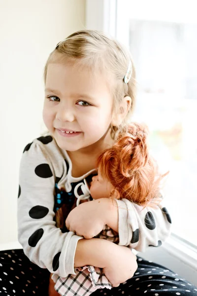 toddler girl with doll