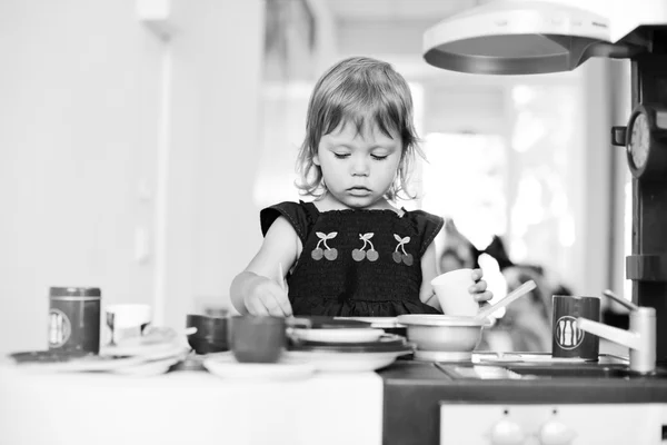 Serious toddler girl is playing — Stock Photo, Image