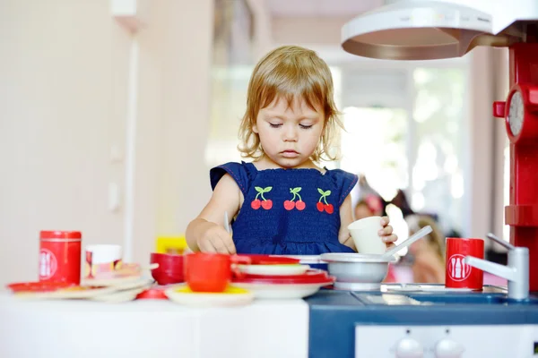 Serious toddler girl is playing — Stock Photo, Image