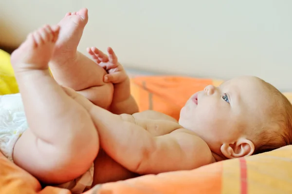 Baby playing with legs — Stock Photo, Image