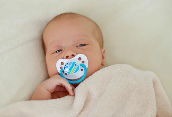 Newborn with dummy — Stock Photo, Image