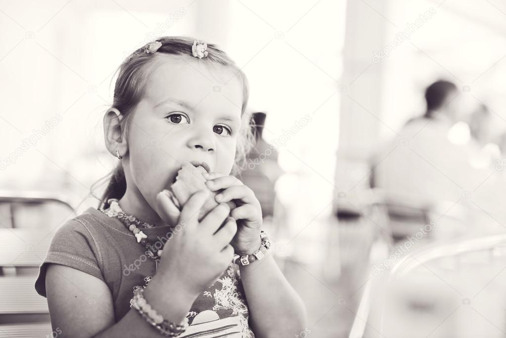 little girl with a hamburger