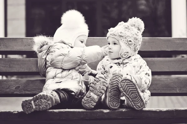 Baby friends on the bench — Stock Photo, Image