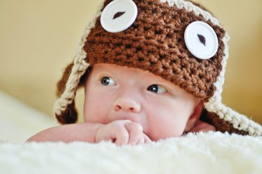 cute newborn wearing funny hat clipart