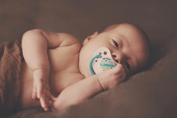 Newborn with dummy — Stock Photo, Image