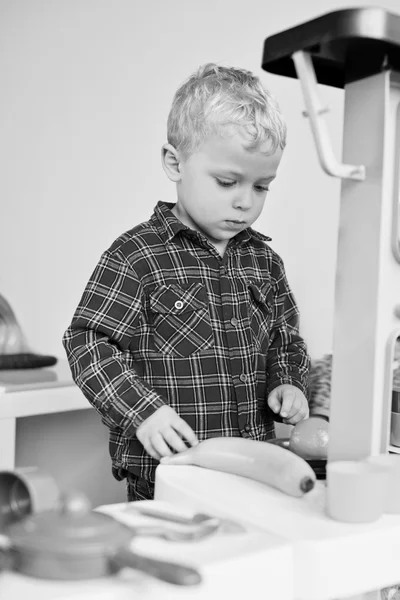 Toddler playing toy kitchen — Stock Photo, Image