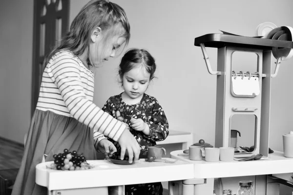 Children  playing toy kitchen — Stock Photo, Image