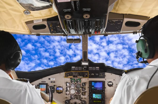 Pilots in the plane cockpit and sky — Stock Photo, Image