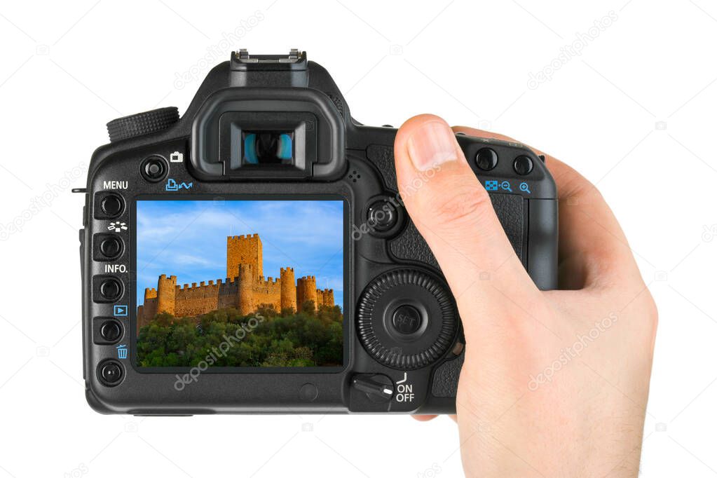 Hand with camera and Almourol castle - Portugal (my photo) isolated on white background
