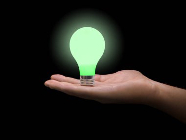 Eldeki aydınlatma lambası siyah arkaplanda izole edildi