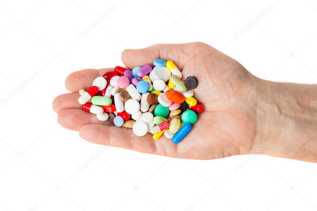 Hand with pills isolated on white background