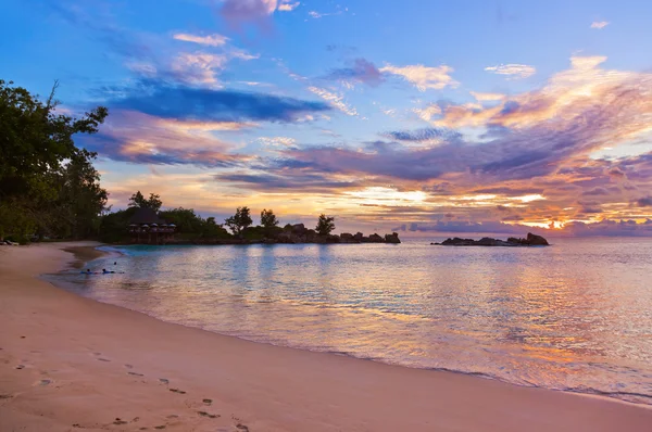 Cafe on Seychelles tropical beach at sunset Royalty Free Stock Images