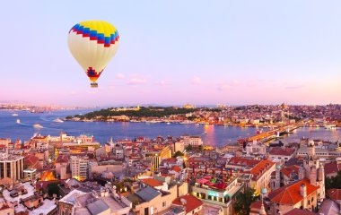 Hot air balloon over Istanbul sunset clipart