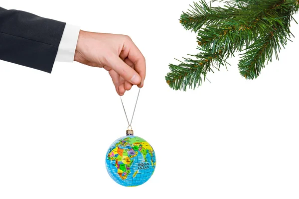 Hand with earth and Christmas tree — Stock Photo, Image