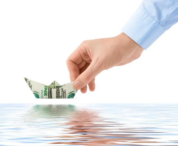 Hand launching money ship — Stock Photo, Image
