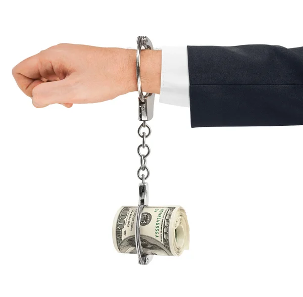 Hand with handcuffs and money — Stock Photo, Image