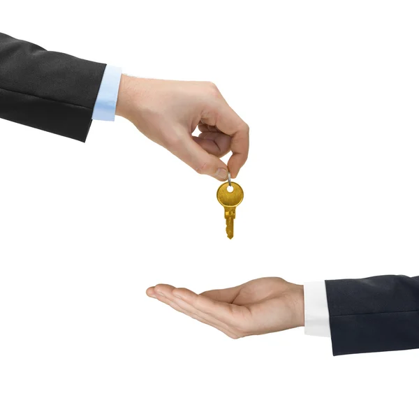 Hands and golden key — Stock Photo, Image