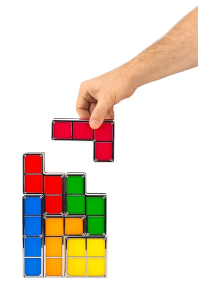 Mão com blocos de brinquedo tetris — Fotografia de Stock