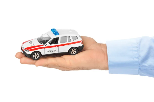 Hand mit Spielzeugauto der Polizei — Stockfoto