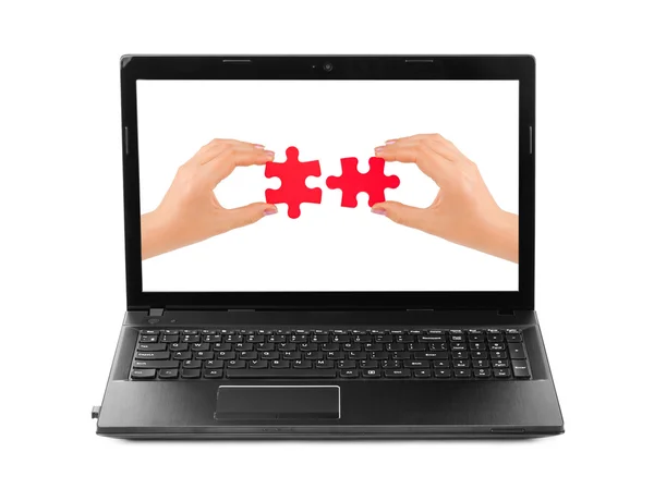 Hands and puzzle in computer notebook — Stock Photo, Image