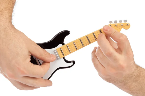 Manos y juguete guitarra eléctrica — Foto de Stock