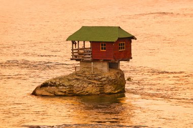 House on rock island in river Drina - Serbia clipart