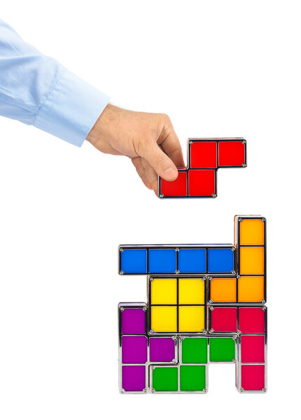Hand with tetris toy blocks