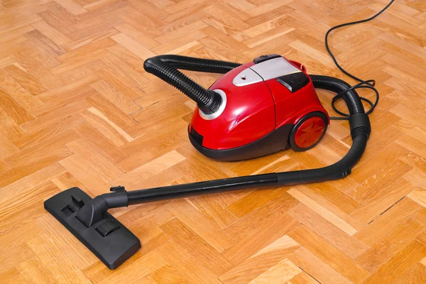 Vacuum cleaner on parquet — Stock Photo, Image