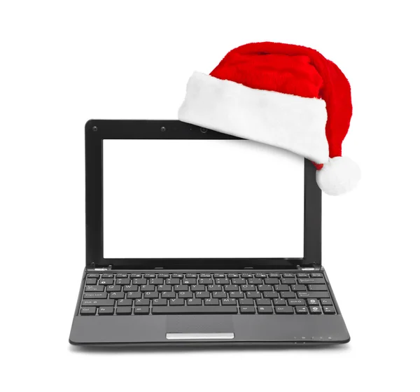 Notebook-computer en Santa Claus rode kerstmuts — Stockfoto