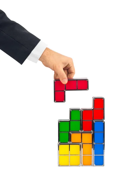 Hand med tetris leksak block — Stockfoto