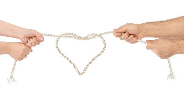 Man and woman hands with heart shaped rope — Stock Photo, Image