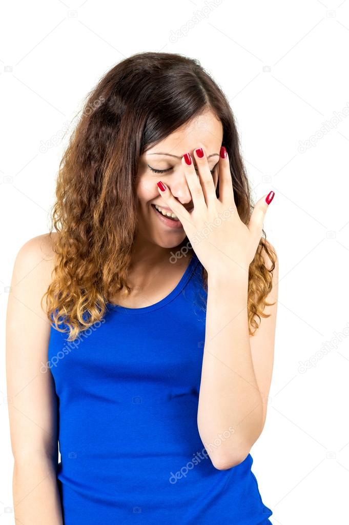 embarrassed girl covers her face with palm