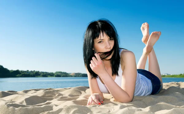 Sexy žena leží na písečné pláži v létě. — Stock fotografie