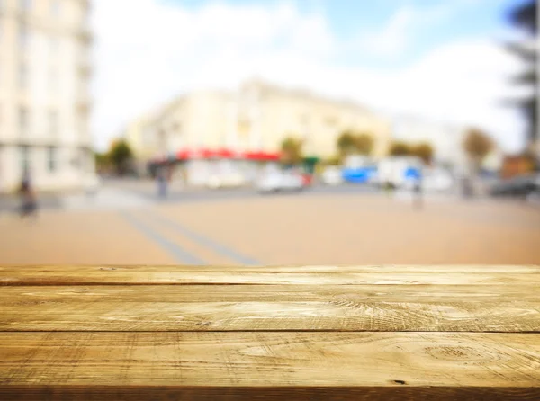 Wooden boards and blurred city — Stock Photo, Image