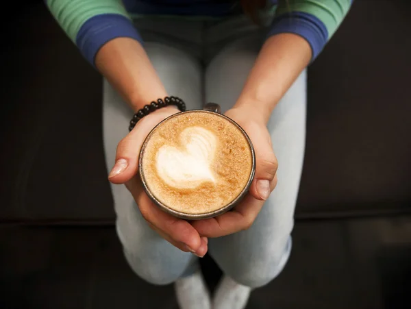 Cup with coffee in female hands — Stock Photo, Image