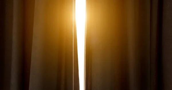 Sunlight enters the room through the curtains