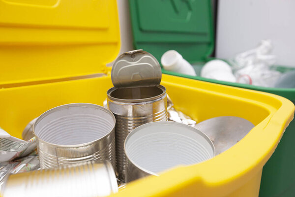 Two full trash cans for sorting garbage. For plastic and cans