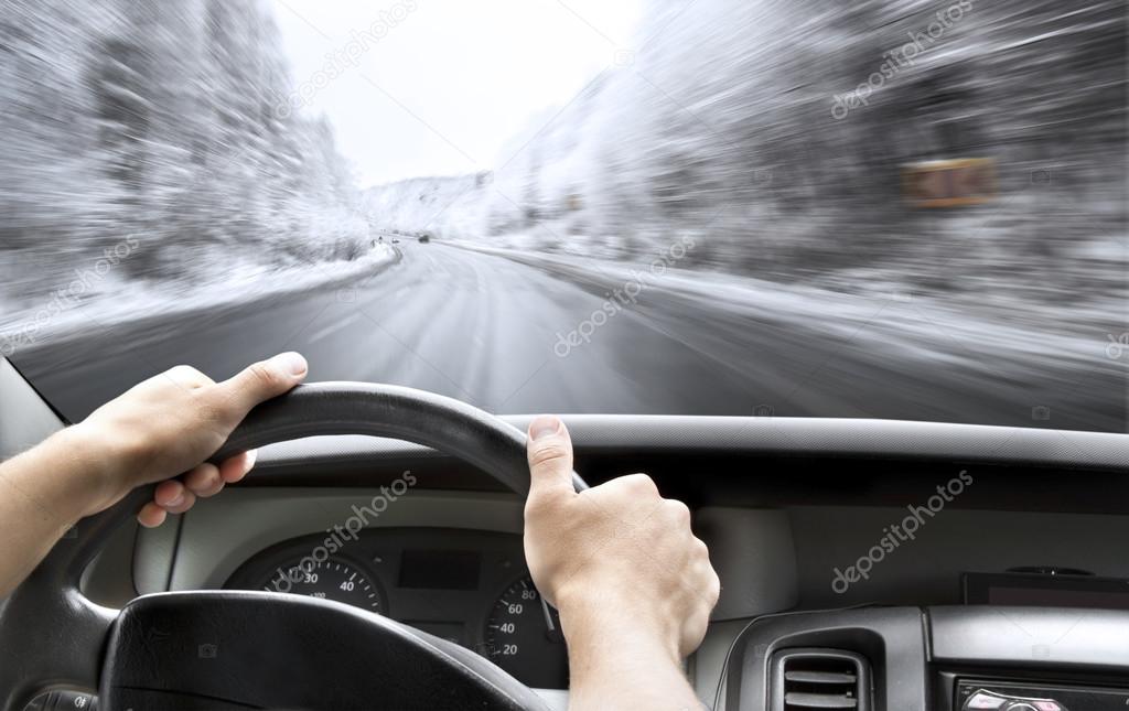 Hands of a driver on steering wheel