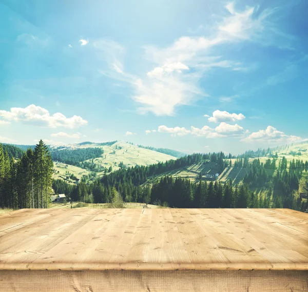 Wooden desk  and panorama of  mountains — Stock Photo, Image