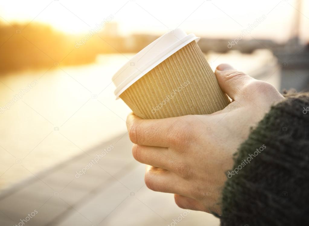 Paper coffee cup in man's hands