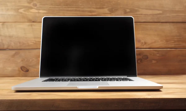 Laptop on wooden table — Stock Photo, Image