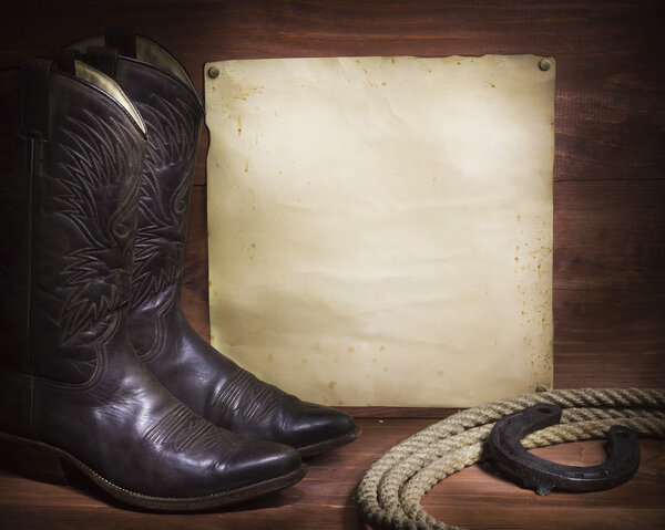  cowboy background with western shoes and lasso and paper