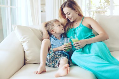 Mother with child drinking juice