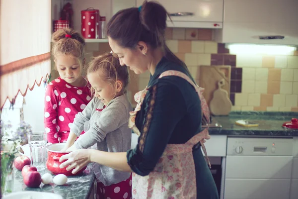 Mother with kids at the kitchen