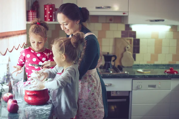 Mother with kids at the kitchen