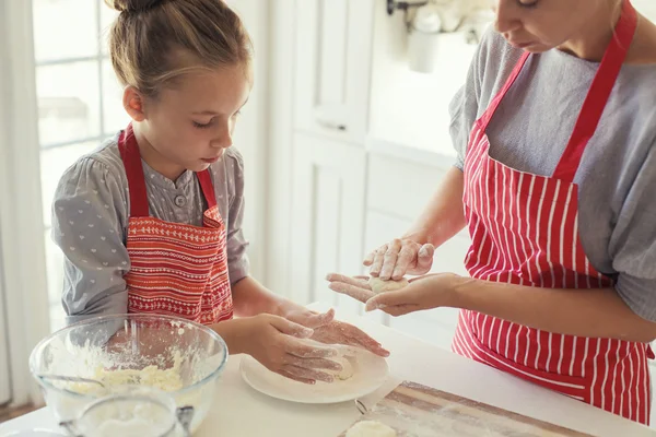 Mother and daughter are cooking