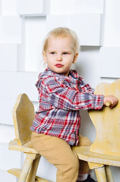 Child riding on the toy horse — Stock Photo, Image