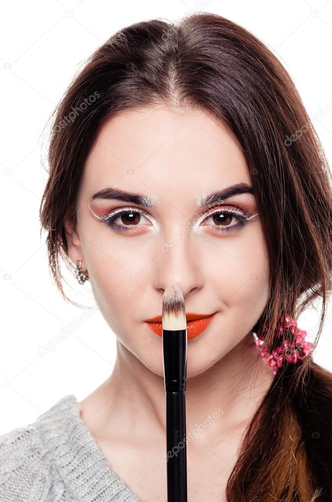 Woman with make-up brushes