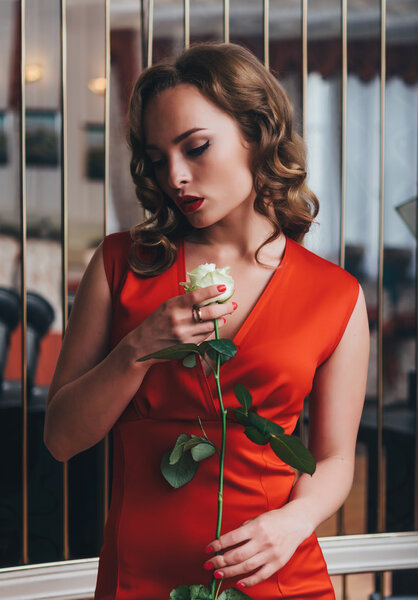 Beautiful woman holding white rose