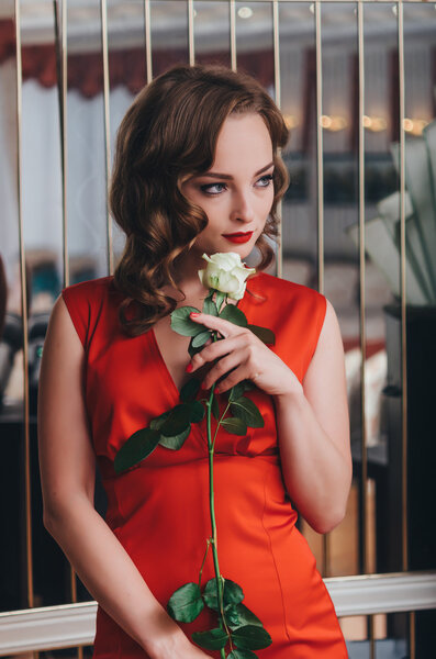 Beautiful woman holding white rose